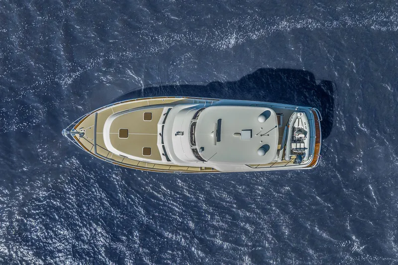 Slide: The Image of Aerial view of 2023 Grand Banks GB54 yacht cruising on open water. - 84