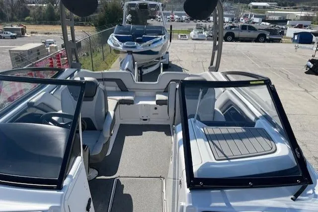 Slide: The Image of 2019 Yamaha Boats AR240 interior with seating and windshield, parked on a trailer. - 4