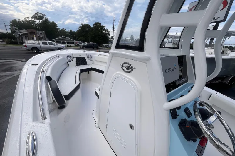 Slide: The Image of 2023 Tidewater 232 CC Adventure boat interior with Garmin navigation system and seating. - 10