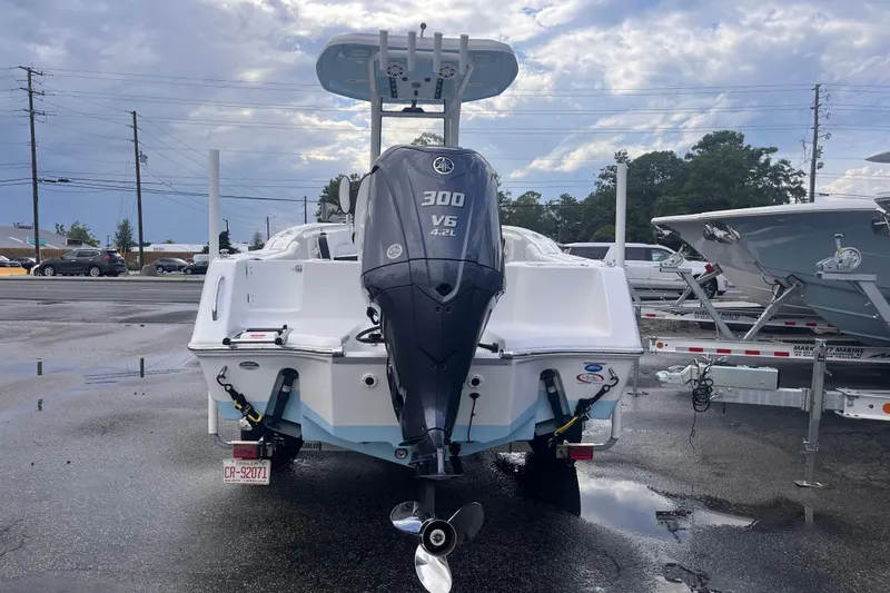 Slide: The Image of 2023 Tidewater 232 CC Adventure boat with Yamaha V6 300 engine, parked outdoors. - 3