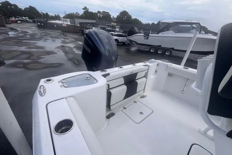 Slide: The Image of 2023 Tidewater 232 CC Adventure boat with Yamaha engine in a wet parking lot. - 5