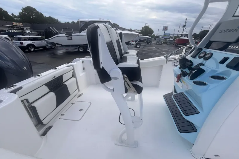 Slide: The Image of 2023 Tidewater 232 CC Adventure boat interior with helm, seating, and controls. - 6