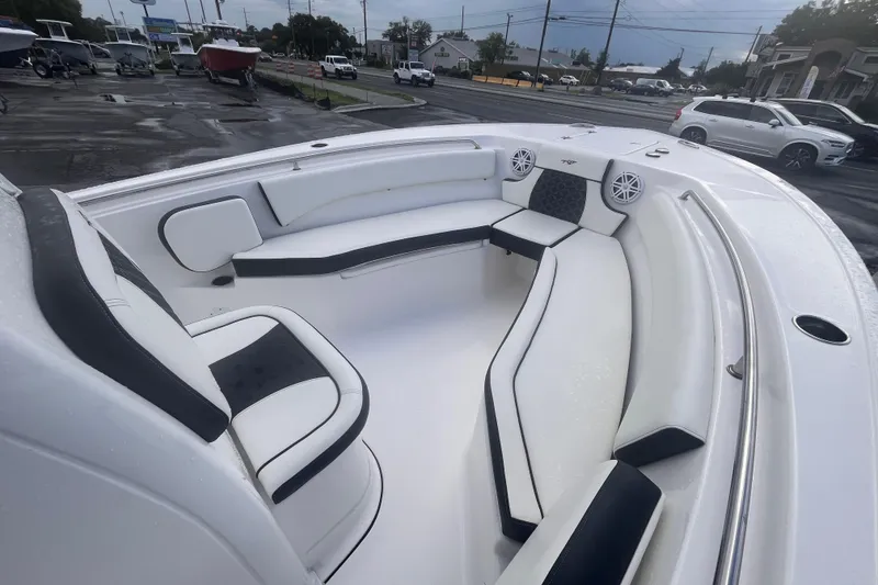 Slide: The Image of 2023 Tidewater 232 CC Adventure boat interior with white seating and speakers. - 9