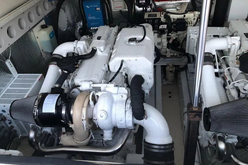 Slide: The Image of Engine room of a 2007 Carolina Classic 35 Express boat, showcasing dual engines and components. - 21