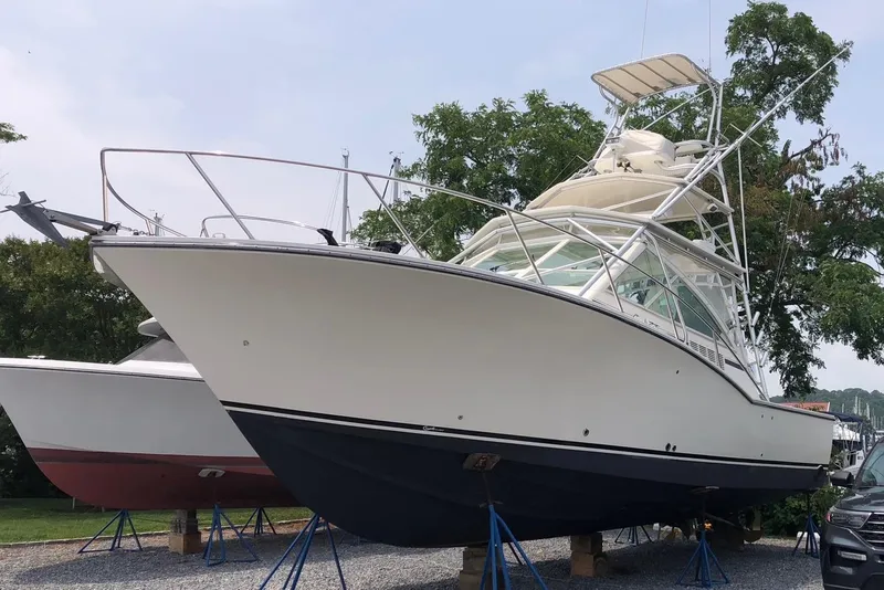 Slide: The Image of 2007 Carolina Classic 35 Express boat on stands, side view, outdoors. - 5