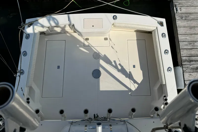 Slide: The Image of 2007 Carolina Classic 35 Express boat deck with rod holders and storage compartments. - 8