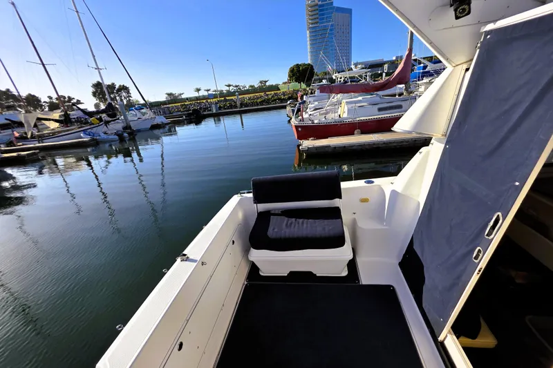 Slide: The Image of 2000 Bayliner 2858 Ciera Command Bridge docked at marina with scenic waterfront view. - 11