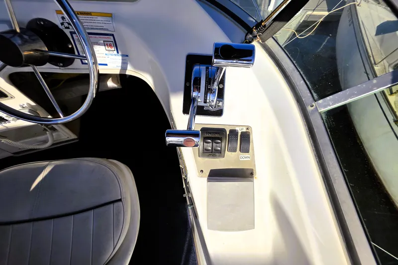 Slide: The Image of 2000 Bayliner 2858 Ciera Command Bridge helm with steering wheel and control panel. - 17