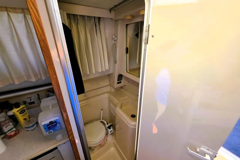 Slide: The Image of Interior of 2000 Bayliner 2858 Ciera Command Bridge bathroom with toilet and sink. - 21