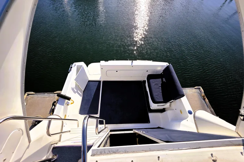 Slide: The Image of Bayliner 2858 Ciera Command Bridge 2000, rear deck view over calm water. - 22