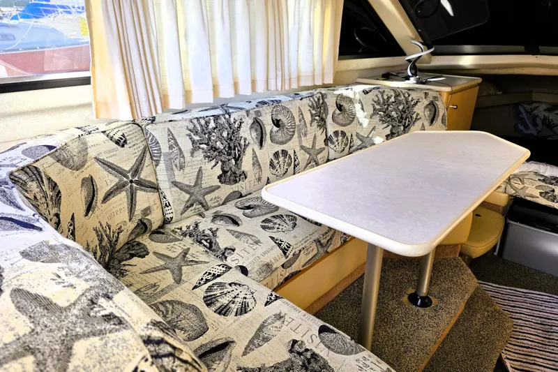 Slide: The Image of Interior of 2000 Bayliner 2858 Ciera Command Bridge with nautical-themed seating and table. - 31