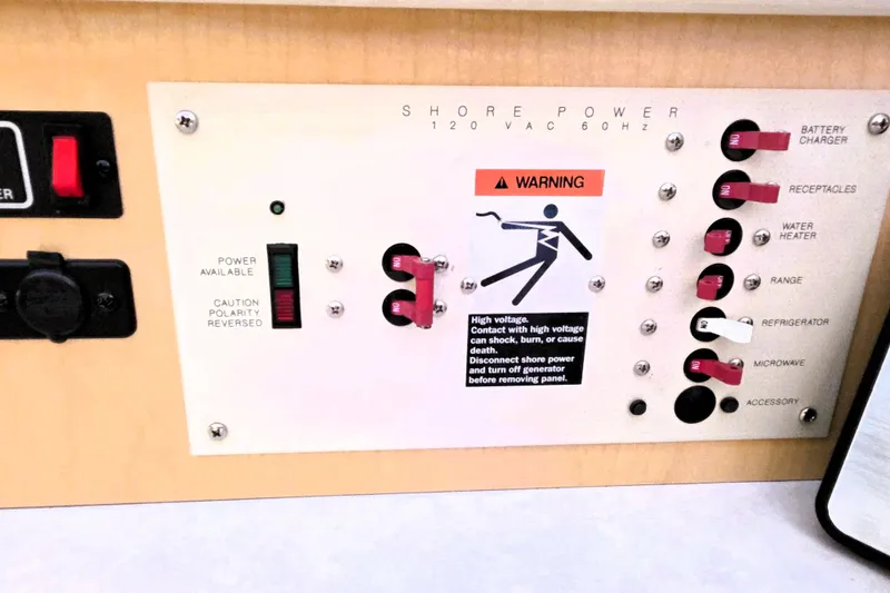 Slide: The Image of Electrical panel on a 2000 Bayliner 2858 Ciera Command Bridge with warning label. - 32