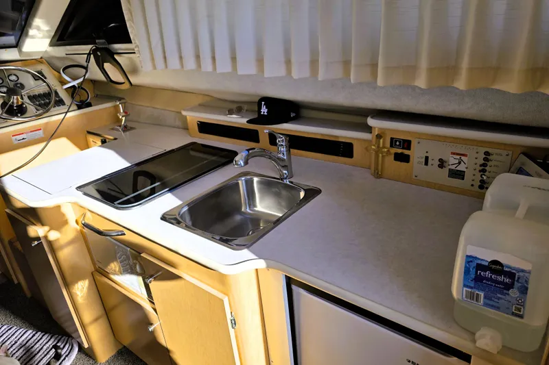 Slide: The Image of Interior of 2000 Bayliner 2858 Ciera Command Bridge with kitchenette and control panel. - 33