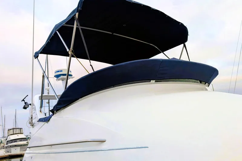 Slide: The Image of 2000 Bayliner 2858 Ciera Command Bridge with blue canopy, docked at marina. - 39