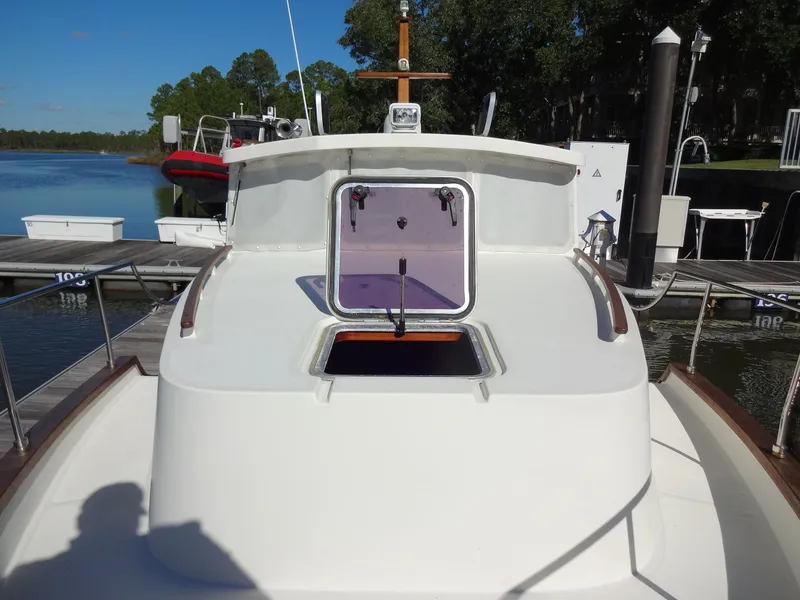 Slide: The Image of 2016 North Aegean 30 boat at dock with open hatch. - 42