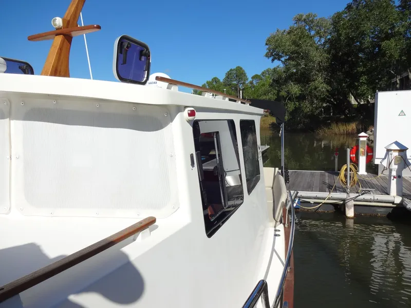 Slide: The Image of North Aegean 30 boat from 2016 docked on a sunny day. - 43