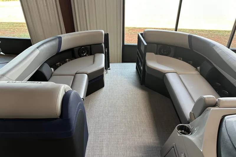 Slide: The Image of Luxurious interior of 2025 Trifecta 24RFCS3 pontoon boat with plush seating and modern design. - 10