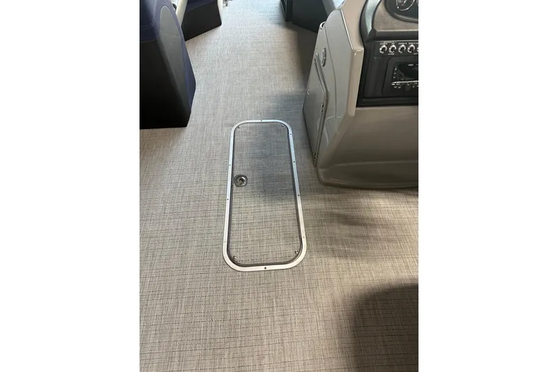 Slide: The Image of 2025 Trifecta 24RFCS3 boat interior with sleek flooring and control panel. - 12