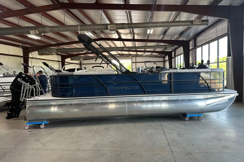 Slide: The Image of 2025 Trifecta 24RFCS3 pontoon boat in a warehouse, featuring sleek design and modern amenities. - 4