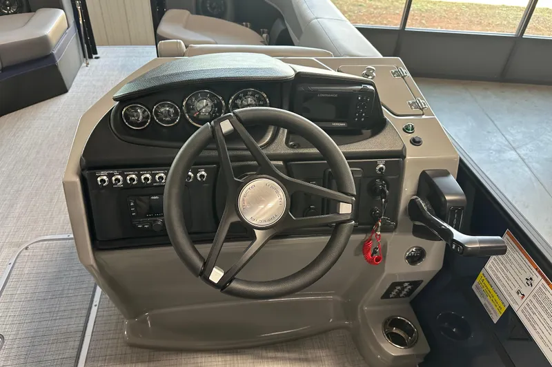 Slide: The Image of 2025 Trifecta 24RFCS3 boat dashboard with steering wheel and control panel. - 7