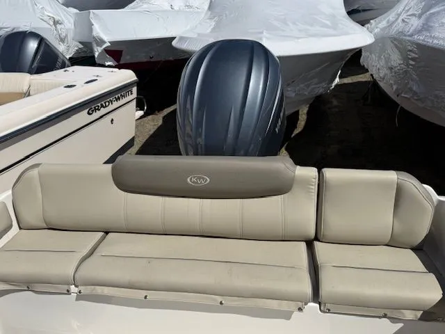 Slide: The Image of 2022 Key West 239 FS boat with beige seating and motor. - 4