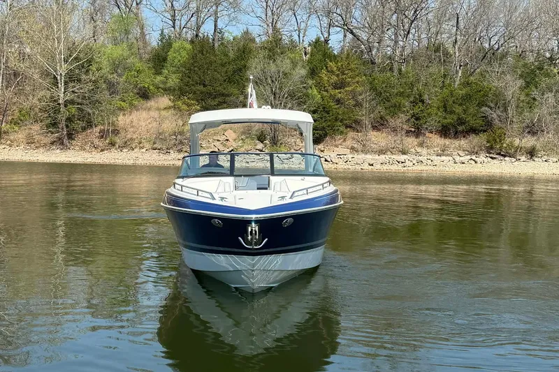 Slide: The Image of 2026 Formula 310 Bowrider I/O on calm lake with wooded shoreline. - 10