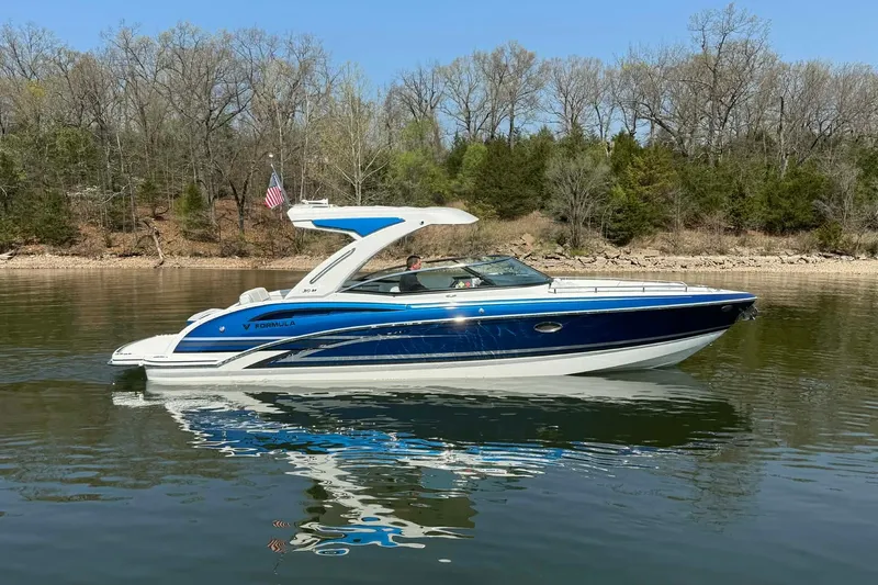 Slide: The Image of 2026 Formula 310 Bowrider I/O boat cruising on a calm lake. - 12