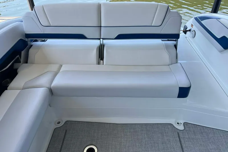 Slide: The Image of 2026 Formula 310 Bowrider I/O boat interior with white and blue seating. - 18