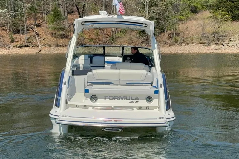 Slide: The Image of 2026 Formula 310 Bowrider I/O cruising on a calm lake with scenic background. - 2