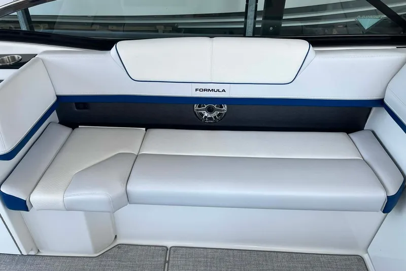 Slide: The Image of 2026 Formula 310 Bowrider I/O boat interior with white and blue cushioned seating. - 20