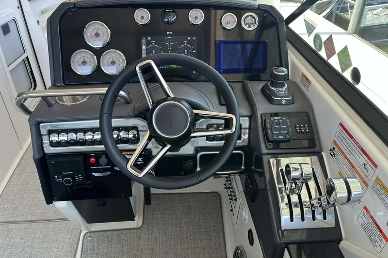Slide: The Image of 2026 Formula 310 Bowrider I/O dashboard with steering wheel and control panel. - 23