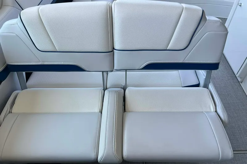 Slide: The Image of Luxury seating on 2026 Formula 310 Bowrider I/O boat, featuring white and blue upholstery. - 24