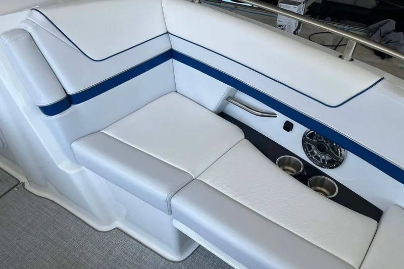 Slide: The Image of 2026 Formula 310 Bowrider I/O interior seating with blue accents and cup holders. - 26