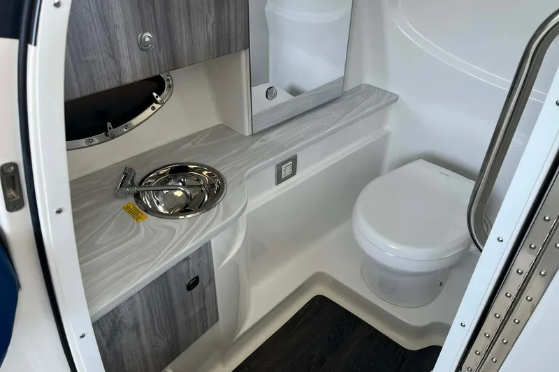 Slide: The Image of Modern bathroom interior of 2026 Formula 310 Bowrider I/O boat, featuring sink and toilet. - 28