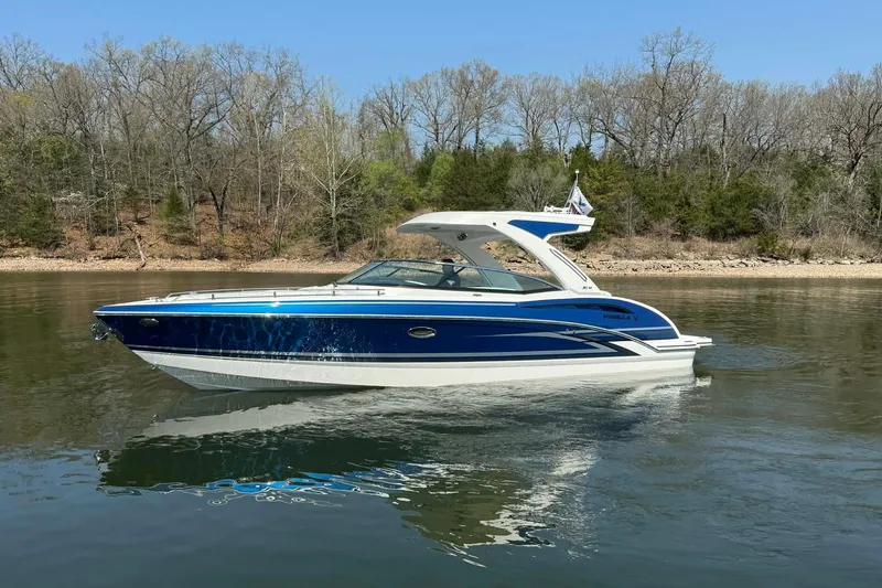 Slide: The Image of 2026 Formula 310 Bowrider I/O boat on calm lake with wooded shoreline. - 8