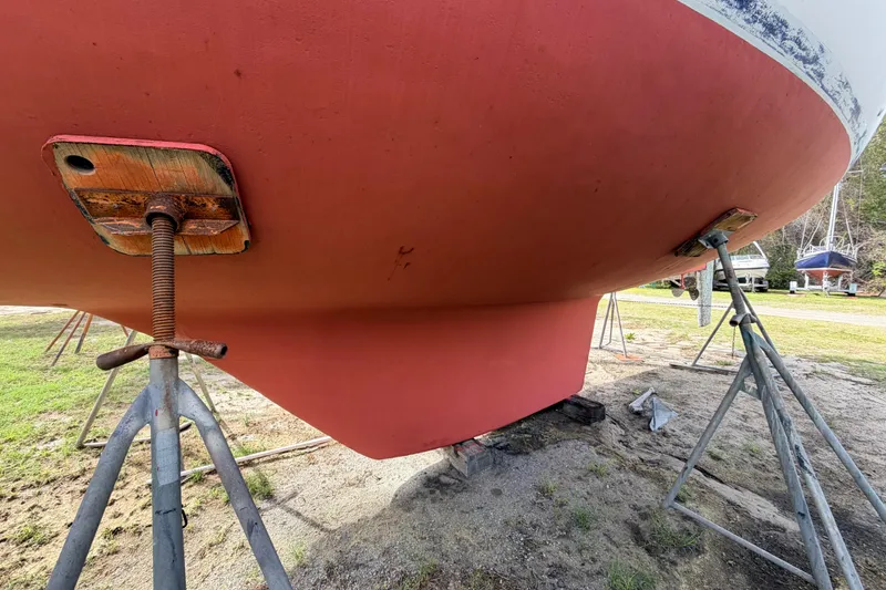 Slide: The Image of 1980 Hunter 37 Cherubini Cutter sailboat hull on stands, ready for maintenance. - 10