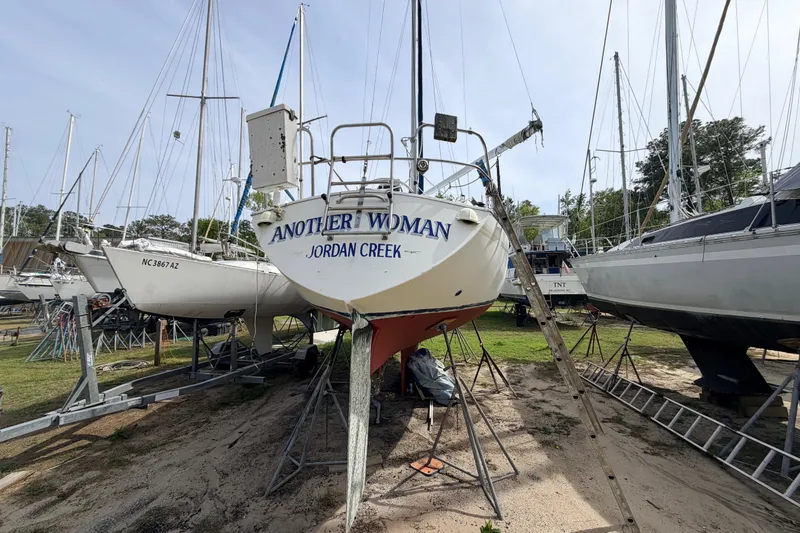 Slide: The Image of 1980 Hunter 37 Cherubini Cutter sailboat on dry dock, named "Another Woman." - 13