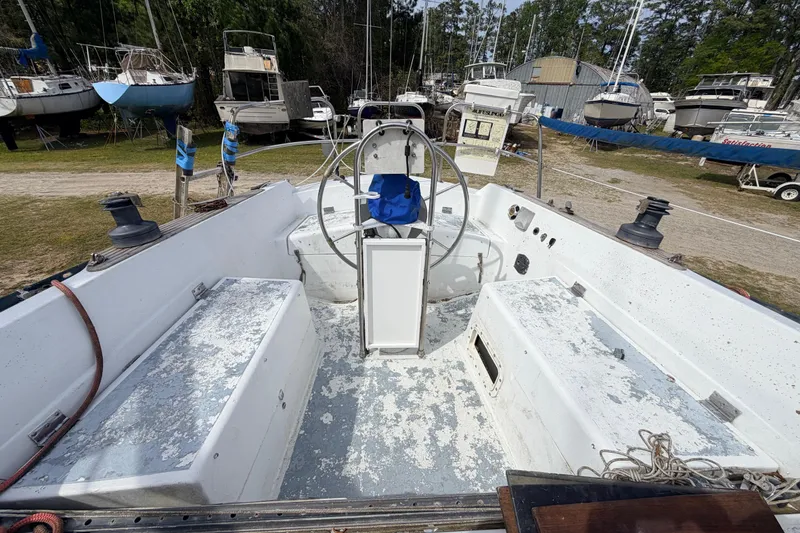 Slide: The Image of Cockpit view of a 1980 Hunter 37 Cherubini Cutter sailboat in a boatyard. - 14