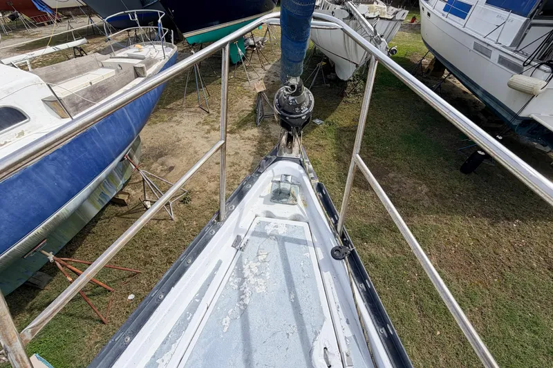Slide: The Image of 1980 Hunter 37 Cherubini Cutter sailboat on land, surrounded by other boats. - 17