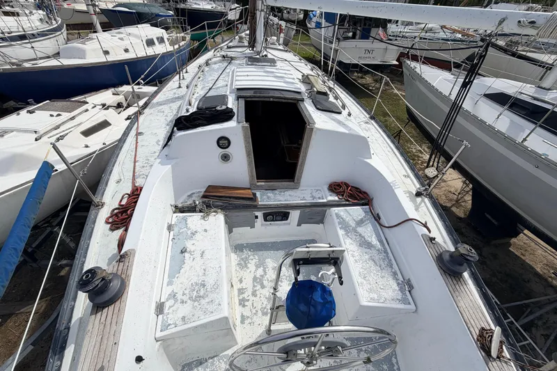 Slide: The Image of 1980 Hunter 37 Cherubini Cutter sailboat deck view, showing cockpit and rigging details. - 21