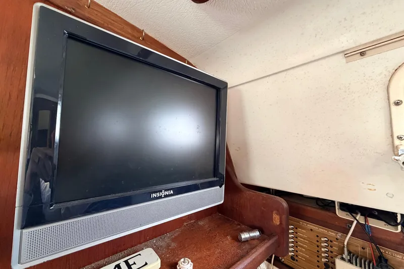 Slide: The Image of Insignia TV inside 1980 Hunter 37 Cherubini Cutter sailboat cabin, wooden interior. - 26