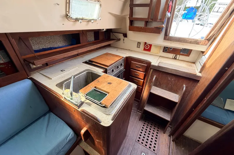 Slide: The Image of 1980 Hunter 37 Cherubini Cutter interior kitchen with wooden cabinetry and sink. - 28