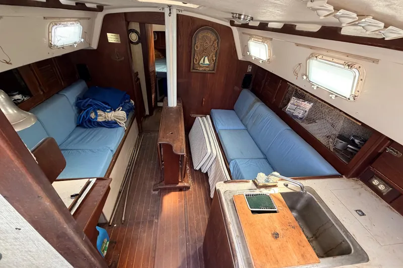 Slide: The Image of Interior of 1980 Hunter 37 Cherubini Cutter with blue seating and wooden finishes. - 30
