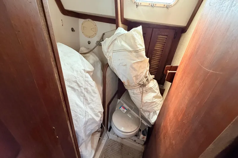 Slide: The Image of Interior of 1980 Hunter 37 Cherubini Cutter with sails stored in compact bathroom. - 34