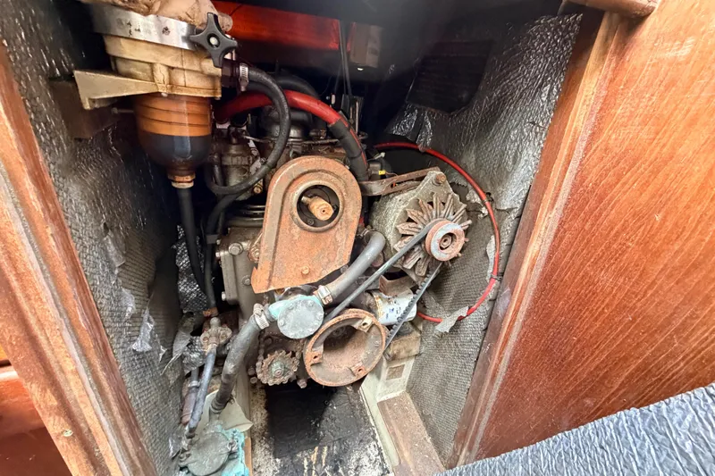 Slide: The Image of Engine compartment of a 1980 Hunter 37 Cherubini Cutter sailboat, showing mechanical components. - 38