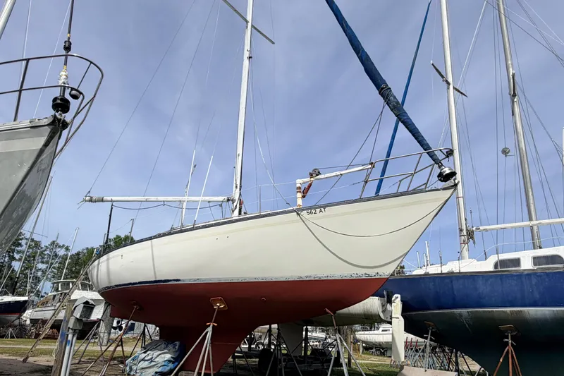 Slide: The Image of 1980 Hunter 37 Cherubini Cutter sailboat on dry dock, with blue sky background. - 5