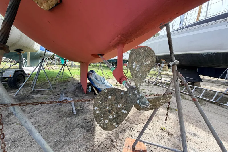 Slide: The Image of 1980 Hunter 37 Cherubini Cutter sailboat on stands, showing propeller and hull. - 8