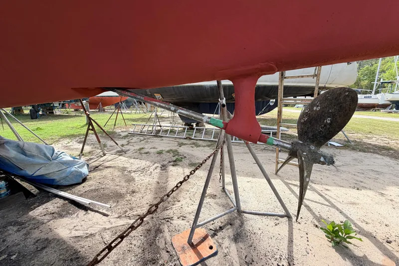 Slide: The Image of 1980 Hunter 37 Cherubini Cutter sailboat on stands, showing propeller and rudder. - 9