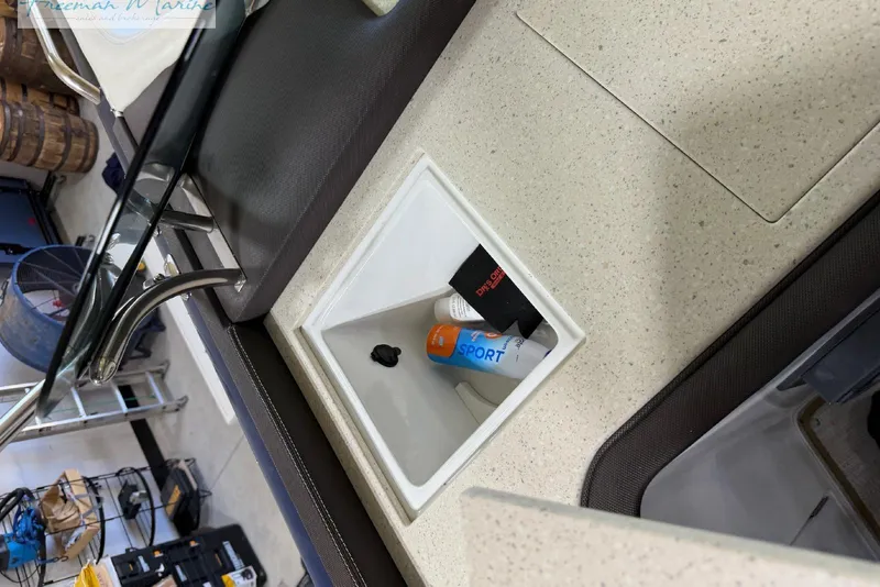 Slide: The Image of Storage compartment on a 2016 Marker One M25 boat with sunscreen and accessories. - 10