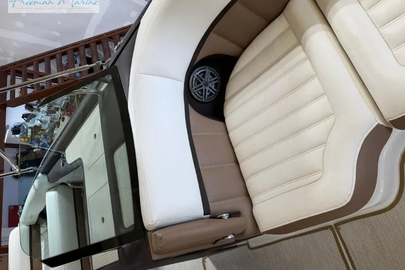 Slide: The Image of Luxurious seating on a 2016 Marker One M25 boat, featuring beige and brown upholstery. - 15